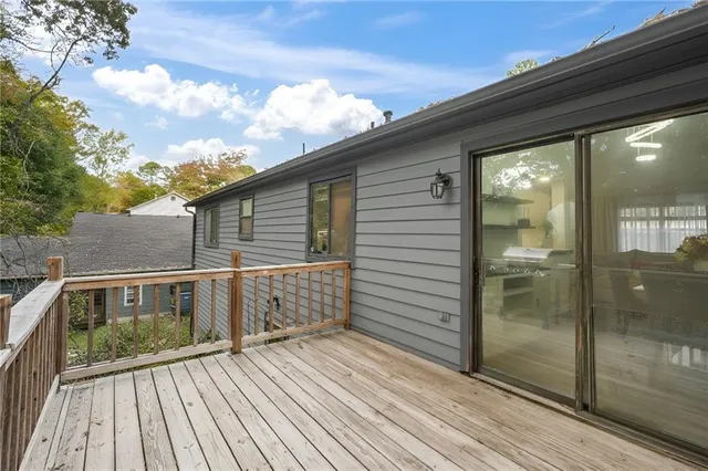 a view of a balcony with wooden floor and iron fence
