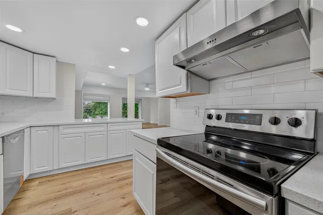 a kitchen with a stove and a microwave