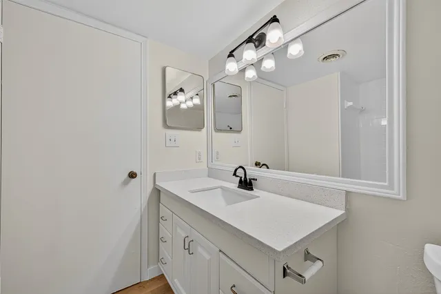 a bathroom with a sink vanity and mirror