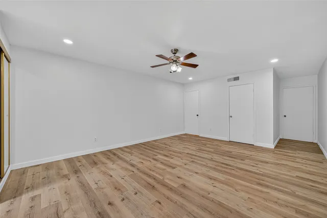 a view of an empty room with a fan