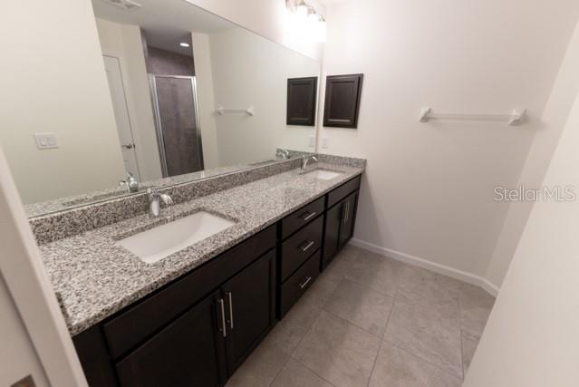 5050 Southwest 91st Place Ocala, FL 34476 - Photo 13 of 33 a bathroom with a granite countertop sink and a mirror