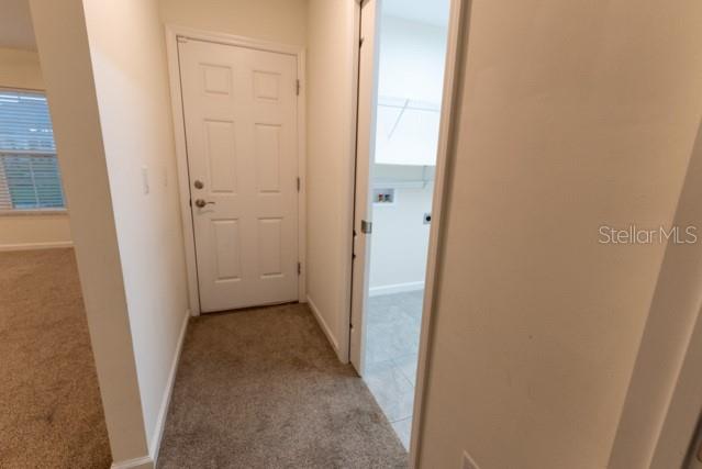 5050 Southwest 91st Place Ocala, FL 34476 - Photo 16 of 33 a view of a hallway with a wooden door