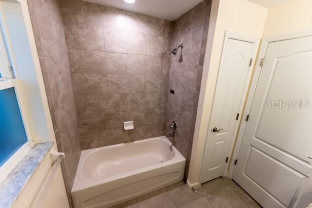 5050 Southwest 91st Place Ocala, FL 34476 - Photo 22 of 33 a bathroom with a white tub a sink and a shower
