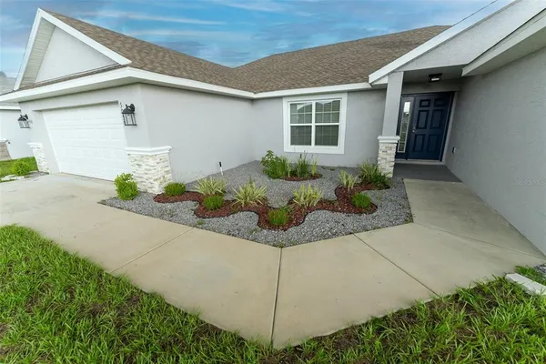 a front view of a house with garage