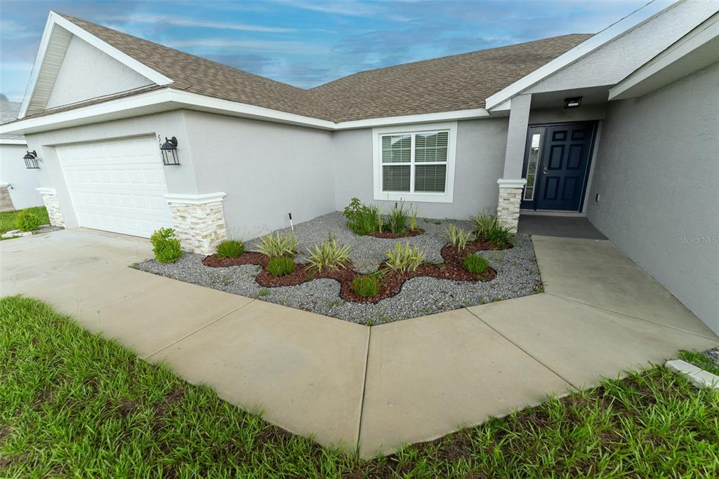 5050 Southwest 91st Place Ocala, FL 34476 - Photo 3 of 33 a front view of a house with garage