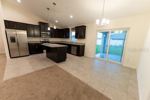 5050 Southwest 91st Place Ocala, FL 34476 - Photo 5 of 33 a large kitchen with a large counter top stainless steel appliances and cabinets