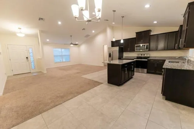 a large kitchen with a large counter top appliances and cabinets