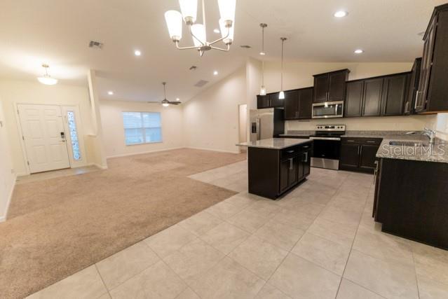 5050 Southwest 91st Place Ocala, FL 34476 - Photo 6 of 33 a large kitchen with a large counter top appliances and cabinets