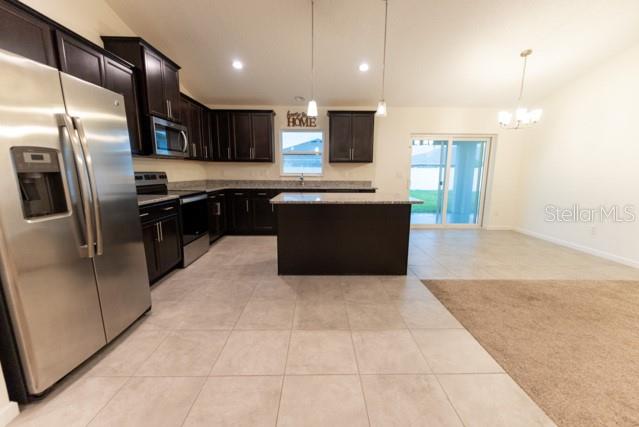5050 Southwest 91st Place Ocala, FL 34476 - Photo 9 of 33 a large kitchen with a large counter top appliances and cabinets