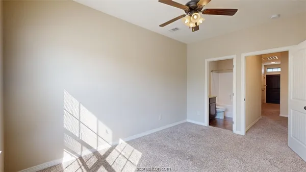 a view of a livingroom with a ceiling fan and window