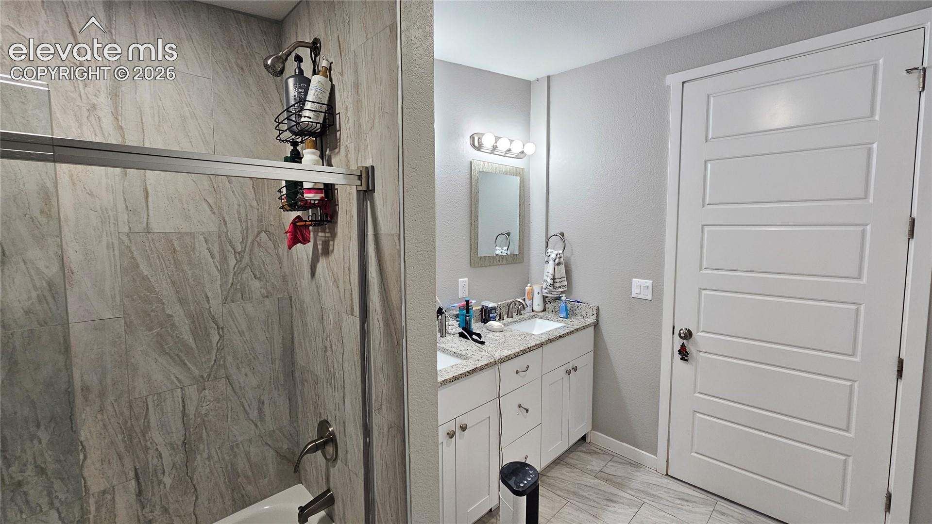 3835 Sengbeil Road Yoder, CO 80864 - Photo 31 of 48 Bathroom featuring a dual vanity with granite countertops, white cabinetry, and brushed nickel fixtures