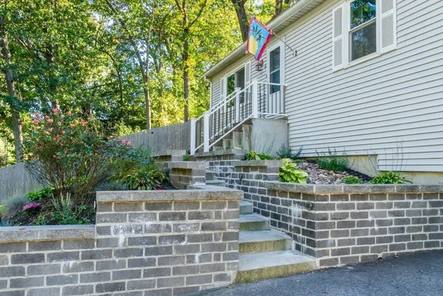 a front view of a house with plants