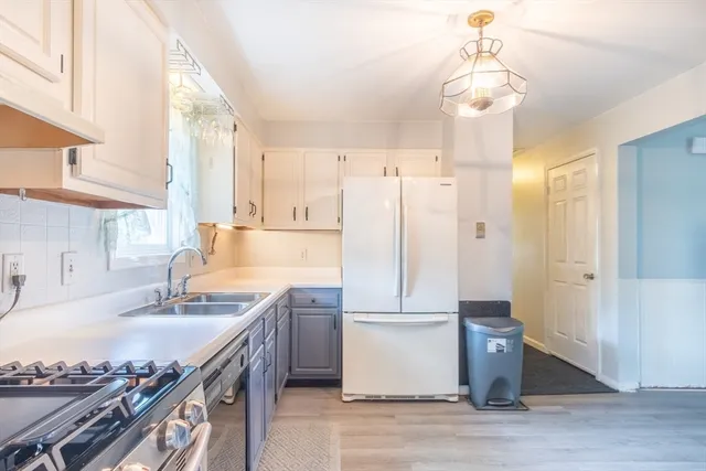 a kitchen with a sink appliances and cabinets