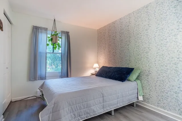 a bedroom with a bed and large window