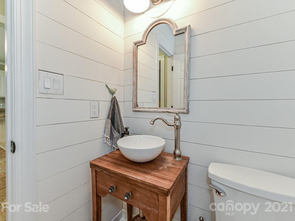 1305 Tom Boyd Road Monroe, NC 28110 - Photo 22 of 48 a bathroom with a toilet a sink and mirror
