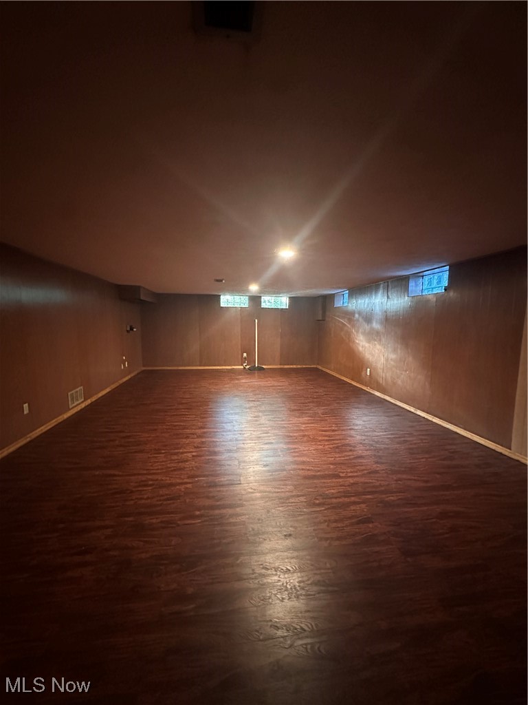 288 Kenridge Road Akron, OH 44333 - Photo 13 of 14 Spare room featuring dark wood-style flooring and plenty of natural light