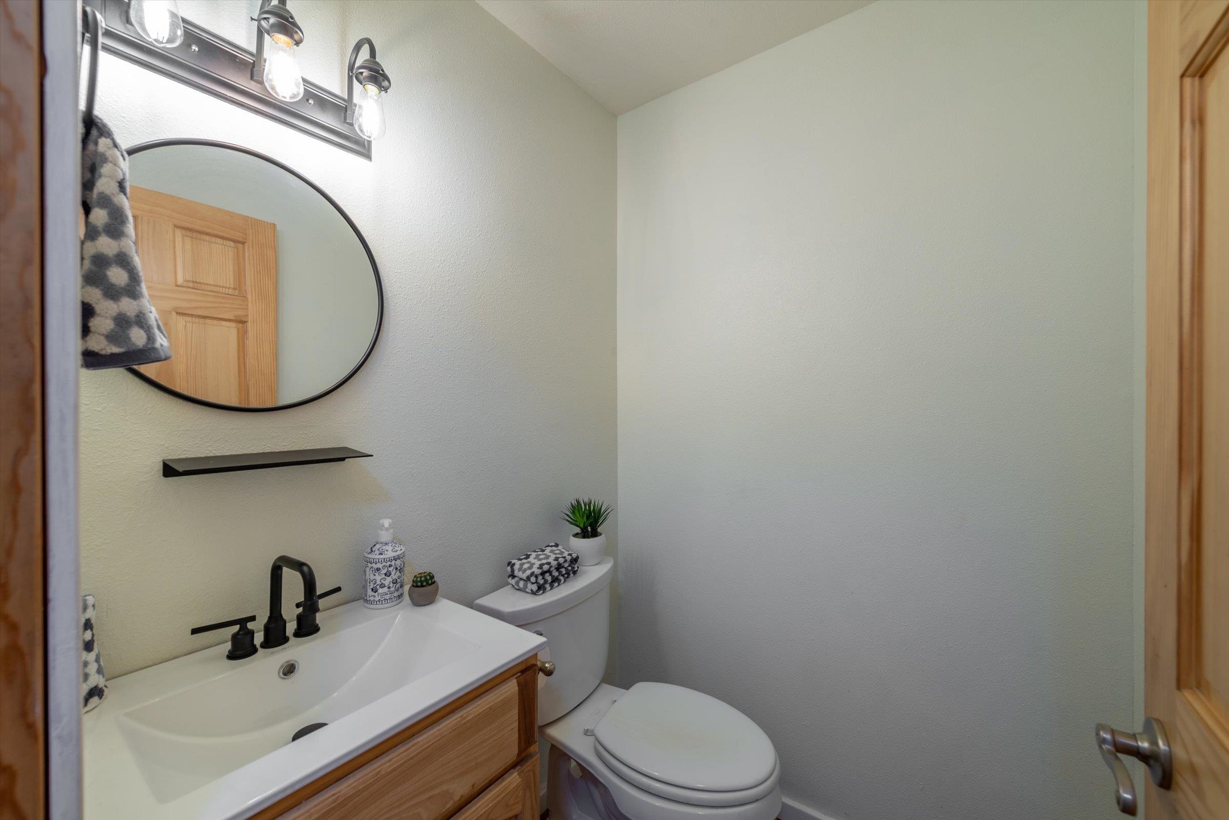 10309 Evensham Place Truckee, CA 96161 - Photo 12 of 21 a bathroom with a sink a toilet and a mirror