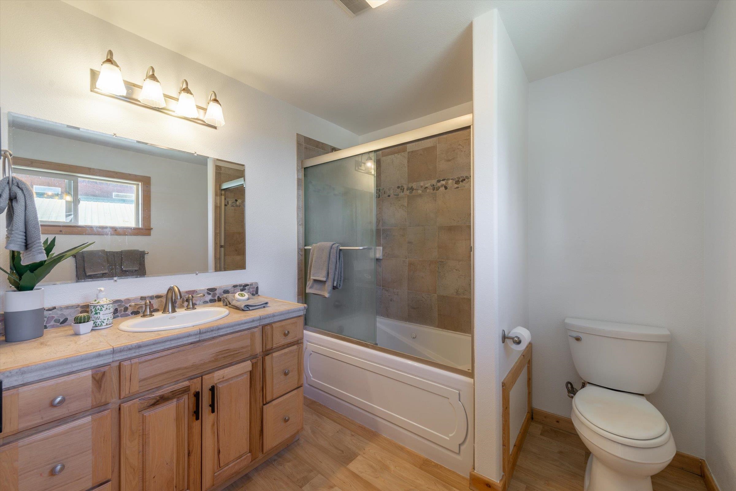 10309 Evensham Place Truckee, CA 96161 - Photo 15 of 21 a bathroom with a sink a toilet a mirror and shower