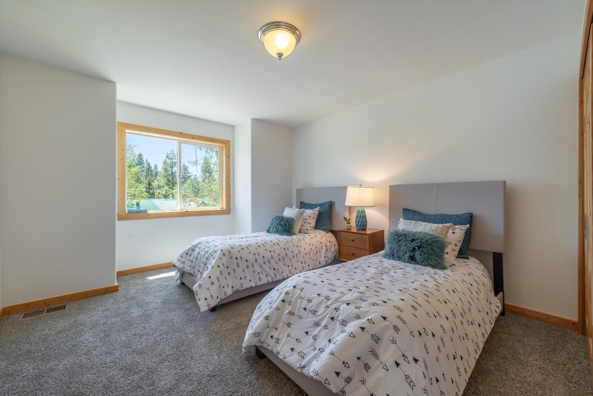 10309 Evensham Place Truckee, CA 96161 - Photo 16 of 21 a bedroom with two beds and a lamp next to a window