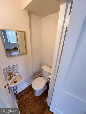 a bathroom with a toilet and a mirror