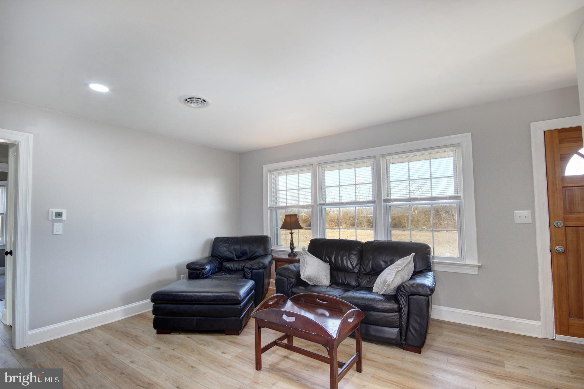 26177 Rewastico Road Hebron, MD 21830 - Photo 9 of 20 a living room with furniture and a large window
