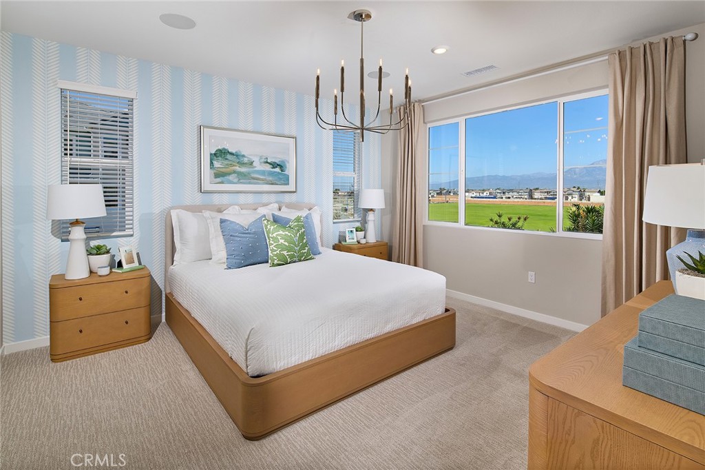 12716 Rosemount Road Eastvale, CA 92880 - Photo 11 of 22 a spacious bedroom with a bed and window