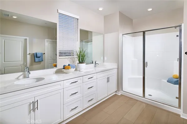 a bathroom with double sink and a mirror