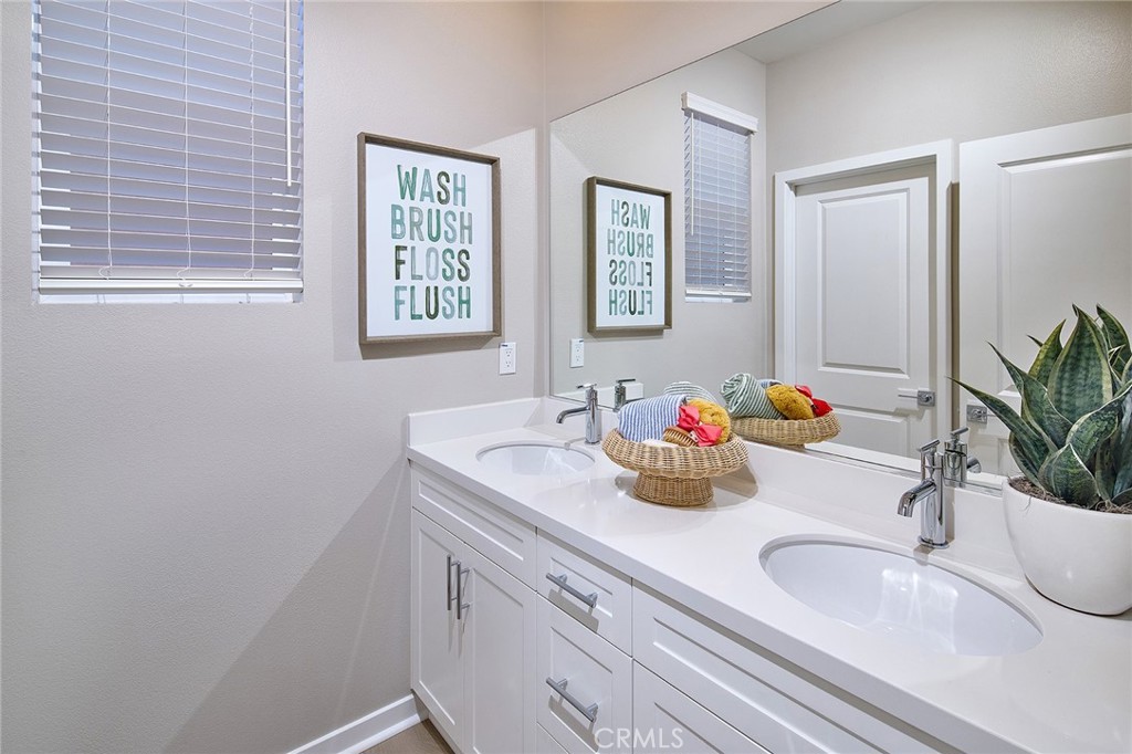 12716 Rosemount Road Eastvale, CA 92880 - Photo 15 of 22 a bathroom with a sink and a mirror