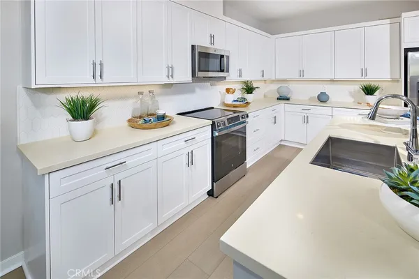 a kitchen with a white cabinets and white appliances