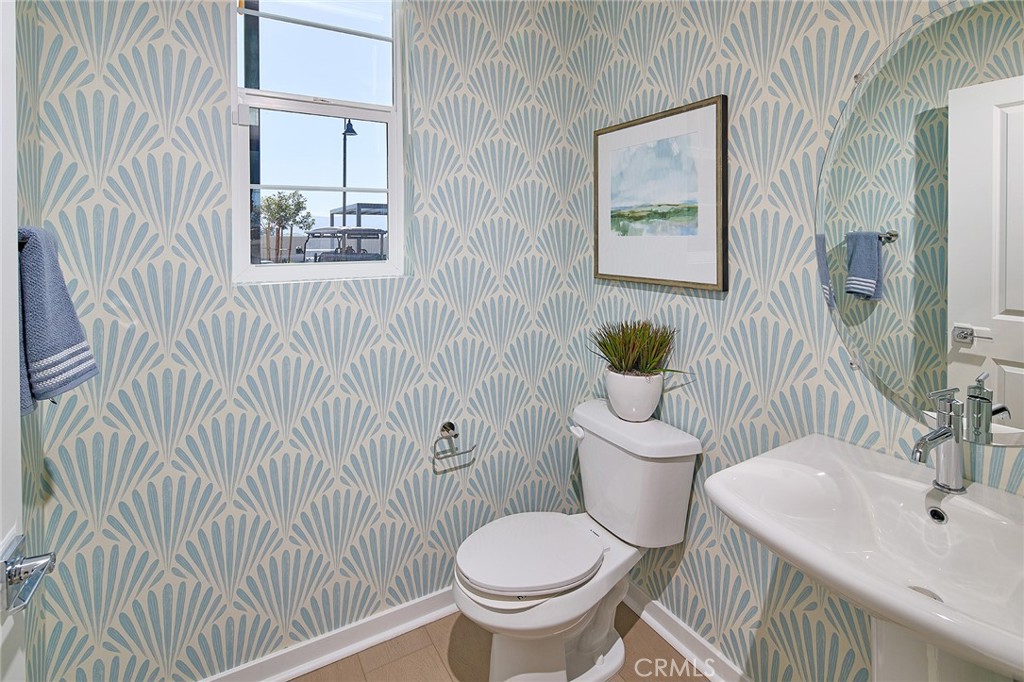 12716 Rosemount Road Eastvale, CA 92880 - Photo 9 of 22 a bathroom with a toilet and a sink