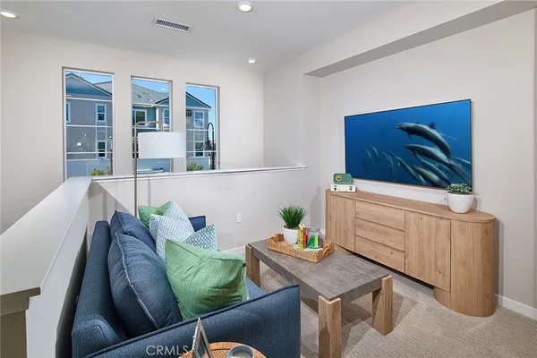 a living room with furniture and flat screen tv