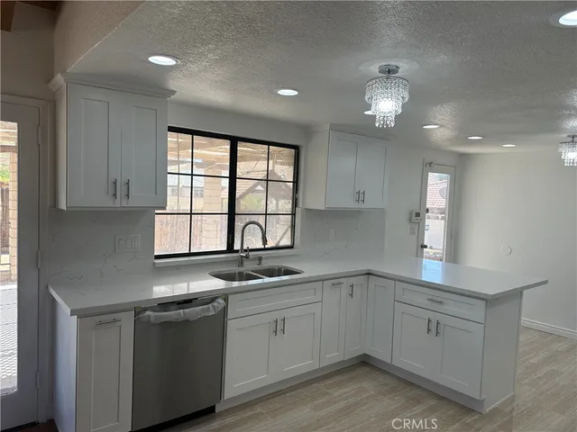 a kitchen that has cabinets stove and sink