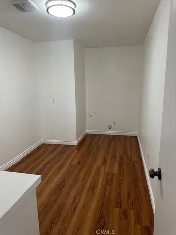 a view of a room with wooden floor and small space