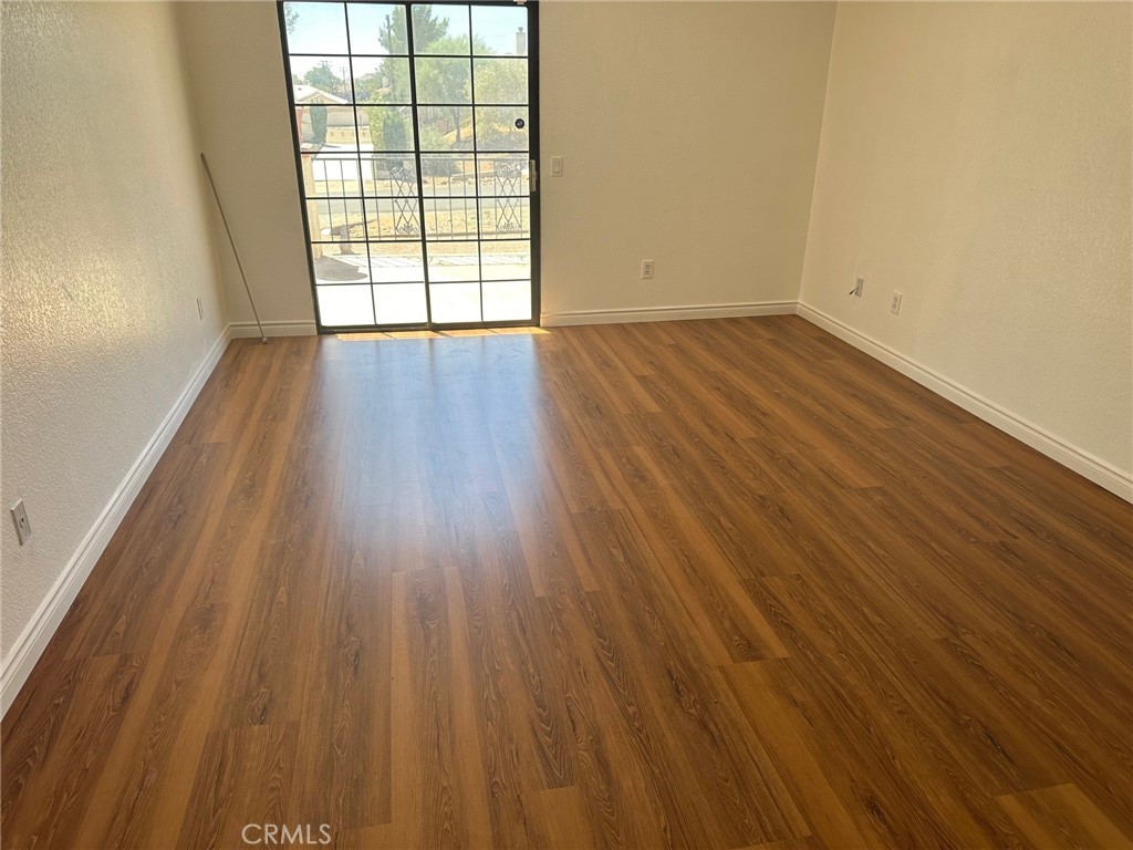 16485 Wintun Road Apple Valley, CA 92307 - Photo 30 of 36 wooden floor in an empty room with a window