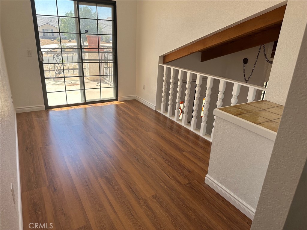 16485 Wintun Road Apple Valley, CA 92307 - Photo 31 of 36 a view of an empty room with wooden floor and a window