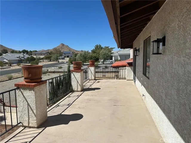 a view of a patio with a table and chairs