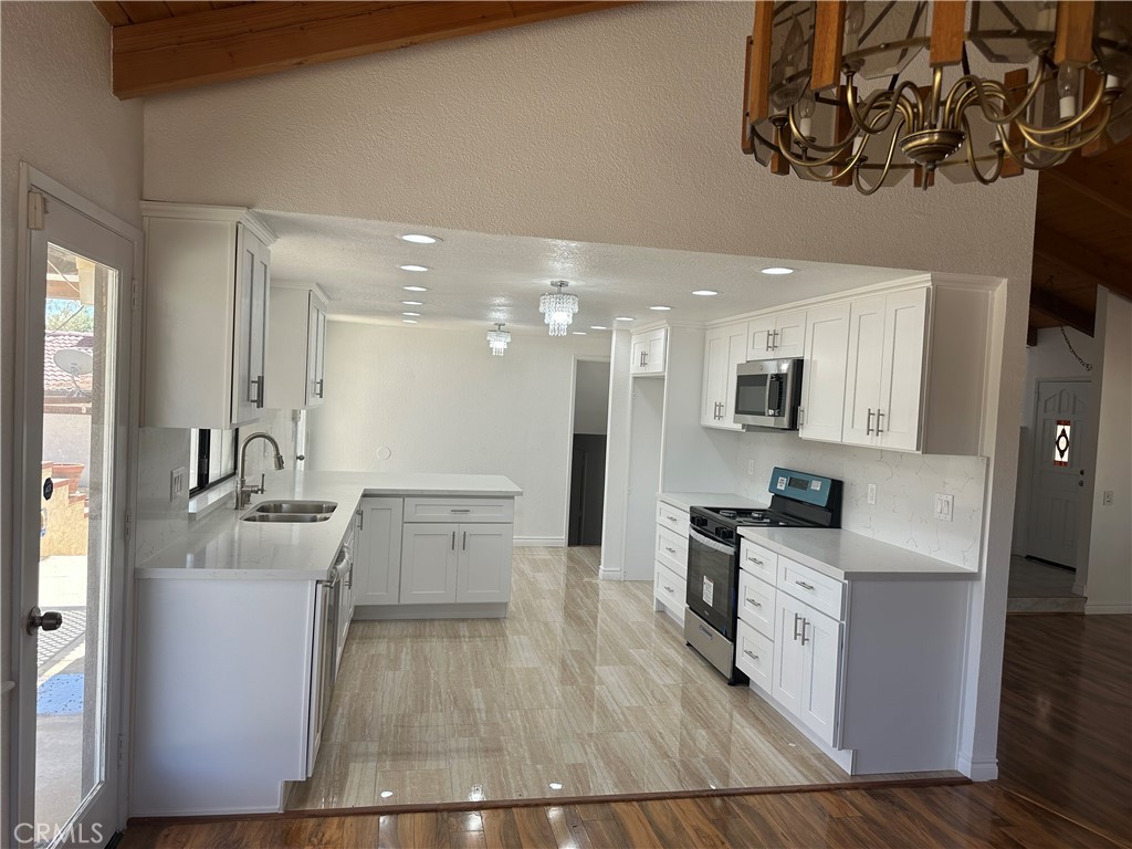 16485 Wintun Road Apple Valley, CA 92307 - Photo 7 of 36 a large kitchen with a lot of counter space