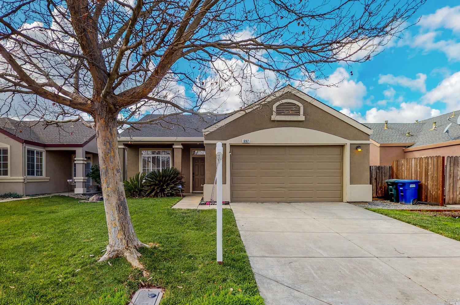 697 Christensen Way Rio Vista, CA 94571 - Photo 1 of 1 a front view of a house with a yard and garage
