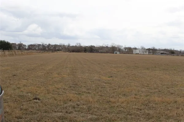 a view of a lake with houses in the back
