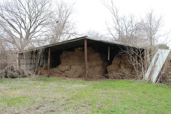 a view of backyard with wooden fence