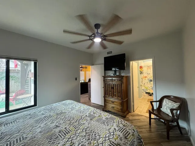 a bedroom with a bed and a flat screen tv