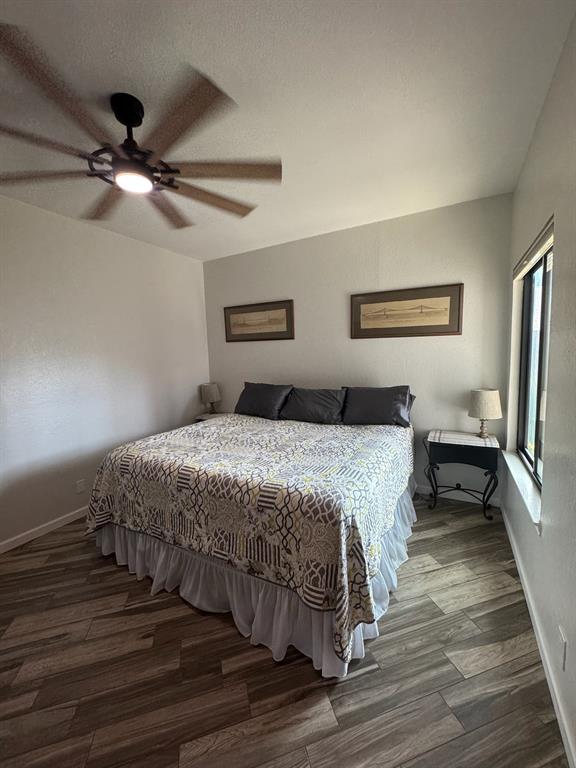 18040 Midway Road, Unit 145 Dallas, TX 75287 - Photo 12 of 19 a bedroom with a bed and a ceiling fan