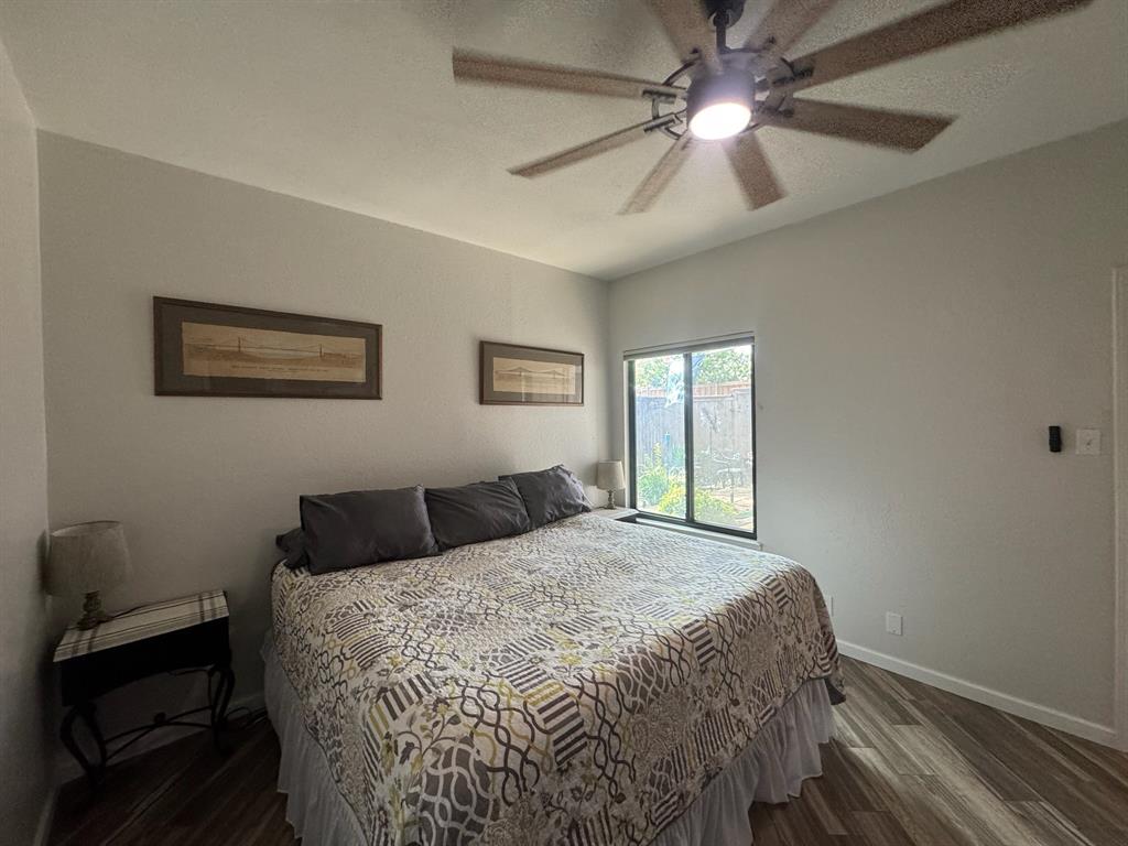 18040 Midway Road, Unit 145 Dallas, TX 75287 - Photo 13 of 19 a bedroom with a bed and a chandelier