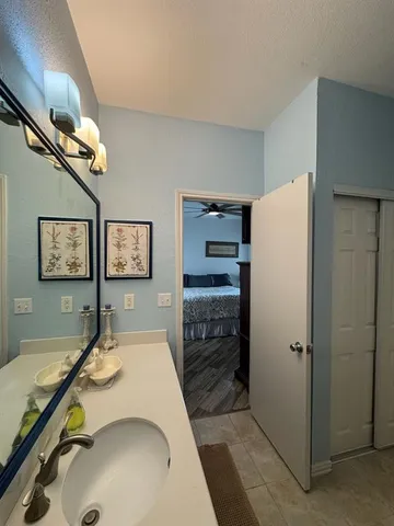 a room with a refrigerator and ceiling fan