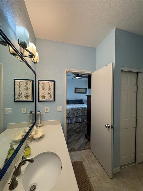 18040 Midway Road, Unit 145 Dallas, TX 75287 - Photo 14 of 19 a room with a refrigerator and ceiling fan