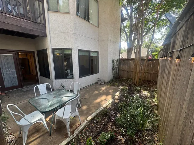 a view of a chairs and table in backyard of the house