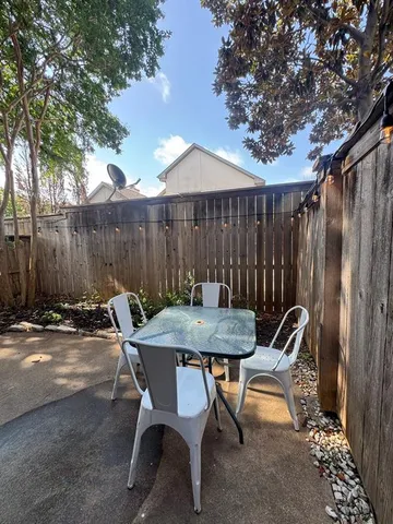 a backyard of a house with table and chairs