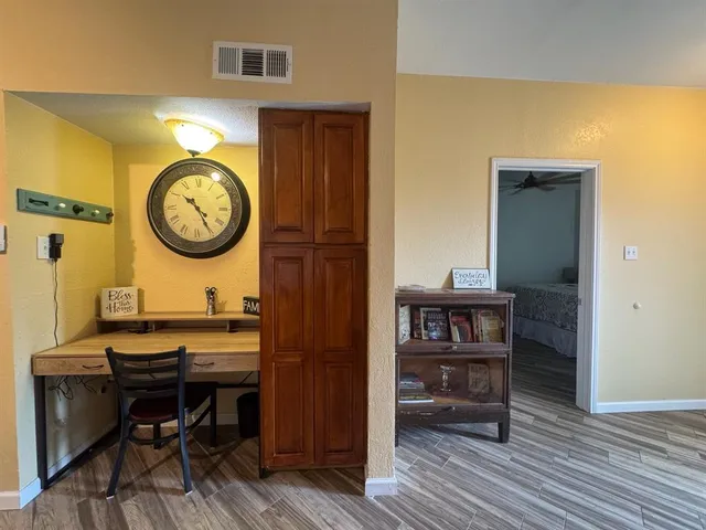 a view of a room that has a table and a chair in it