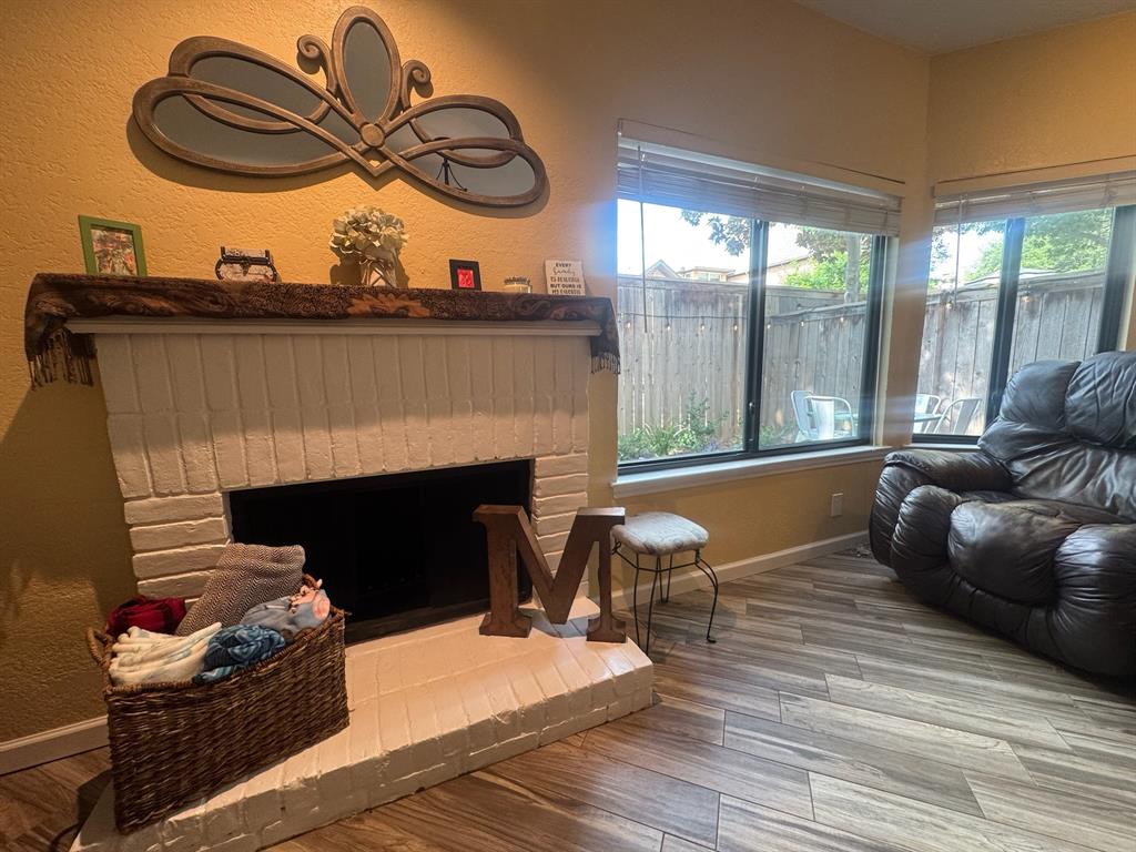 18040 Midway Road, Unit 145 Dallas, TX 75287 - Photo 8 of 19 a living room with furniture a fireplace and floor to ceiling window