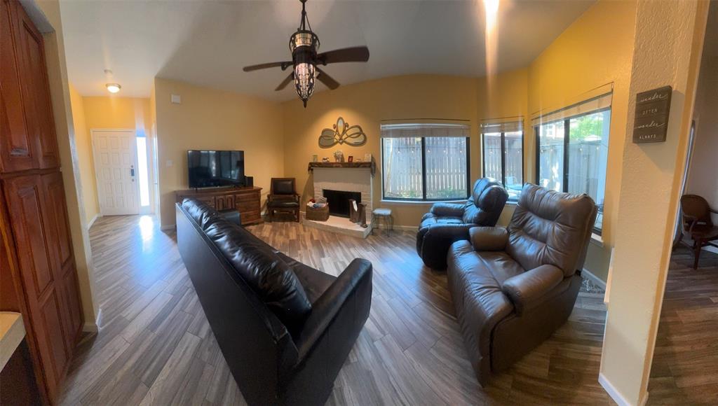 18040 Midway Road, Unit 145 Dallas, TX 75287 - Photo 10 of 19 a living room with fireplace furniture and a large window